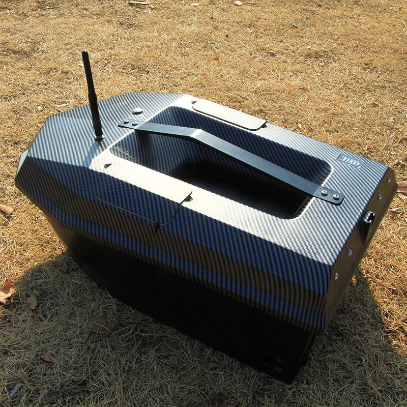 Manuowell Assassin bait boat from above showing the large open bait hopper and carry handle