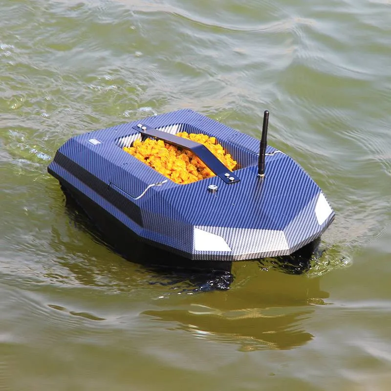 Manuowell Assassin bait boat on the water with its hopper full of groundbait